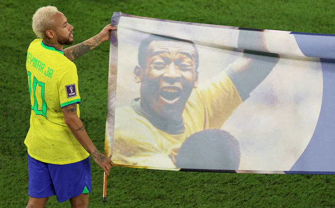 Brazil's Neymar helped carry a banner honoring Pelé during the World Cup in Qatar. (Pedro Nunes/Reuters)